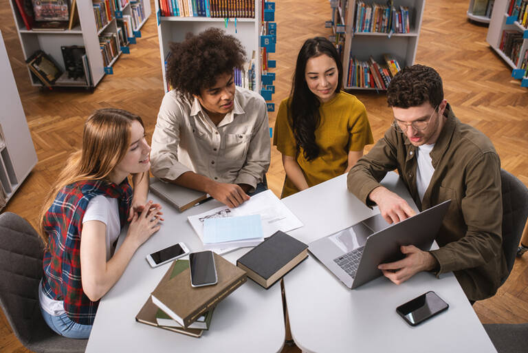 University Students Are Studying In A Library Together. Concept Of Teamwork And Preparation