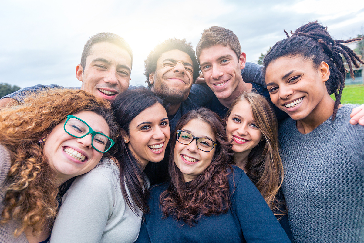 Multiracial People Together In A Selfie Making Funny Faces Gro