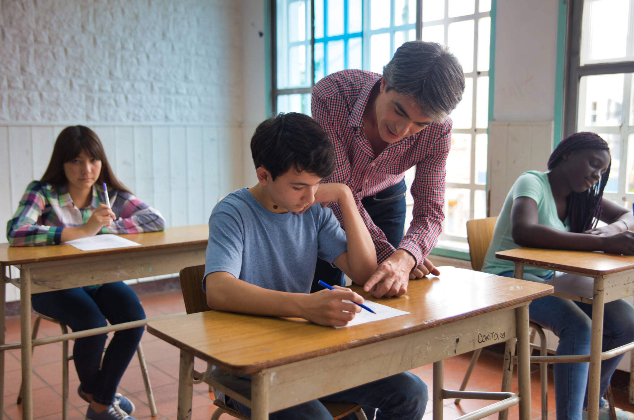 Teenagers At School. Multi Ethnic Classroom Making Test Teenagers At School. Multi Ethnic Classroom Making Test